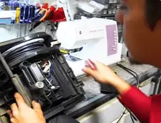 Vacuum repair technician servicing internal components on a workbench in Birmingham, AL